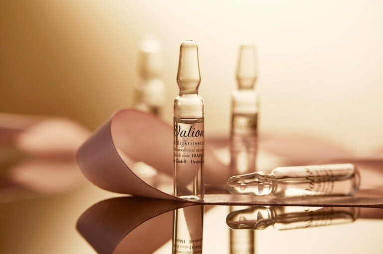 a table topped with bottles of liquid next to a pair of scissors